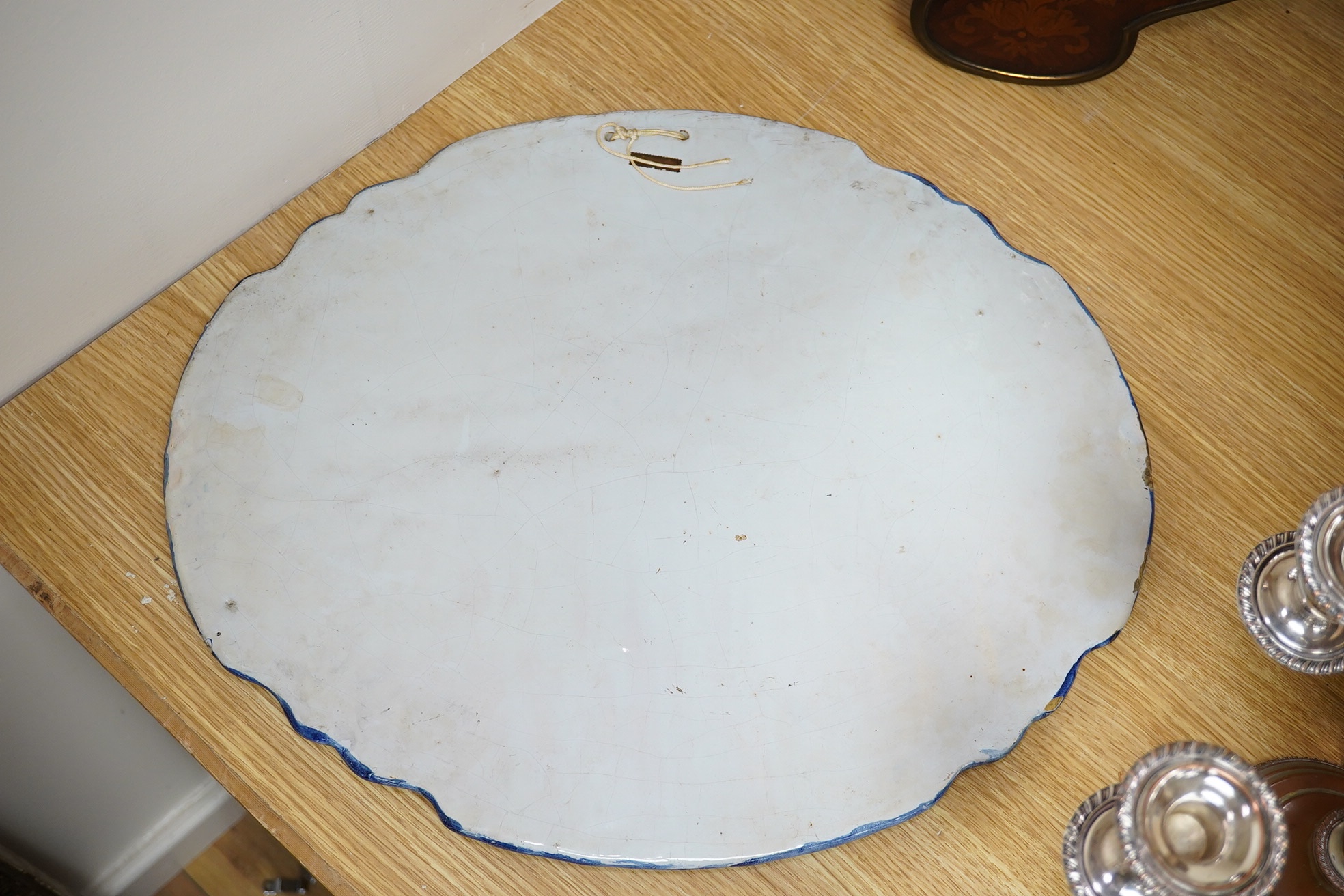 A 19th century Dutch delt shaped oval plaque, 53cm wide. Condition - fair to good